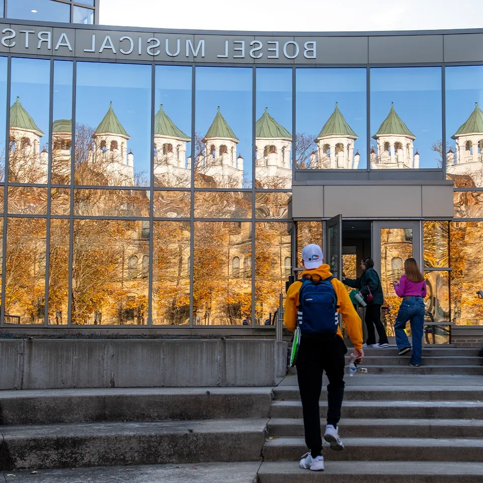 Music student on the front steps of the BW Conservatory of Performing Arts